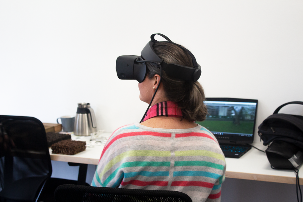 A mid shot of a participant with a VR headset on, looking to their left.